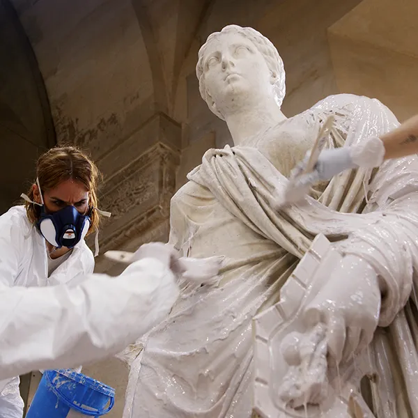 Photo taken in the storage facilities of the Palace of Versailles. Wide shot of our artisans applying the liquid elastomer