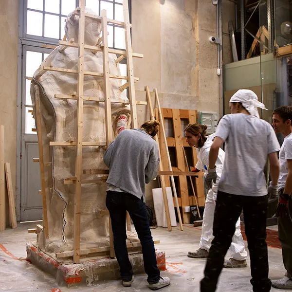 Photo taken in the storage facilities of the Palace of Versailles. Wide shot of our artisans finalizing the wooden frame